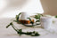 Cream jars with green leaves